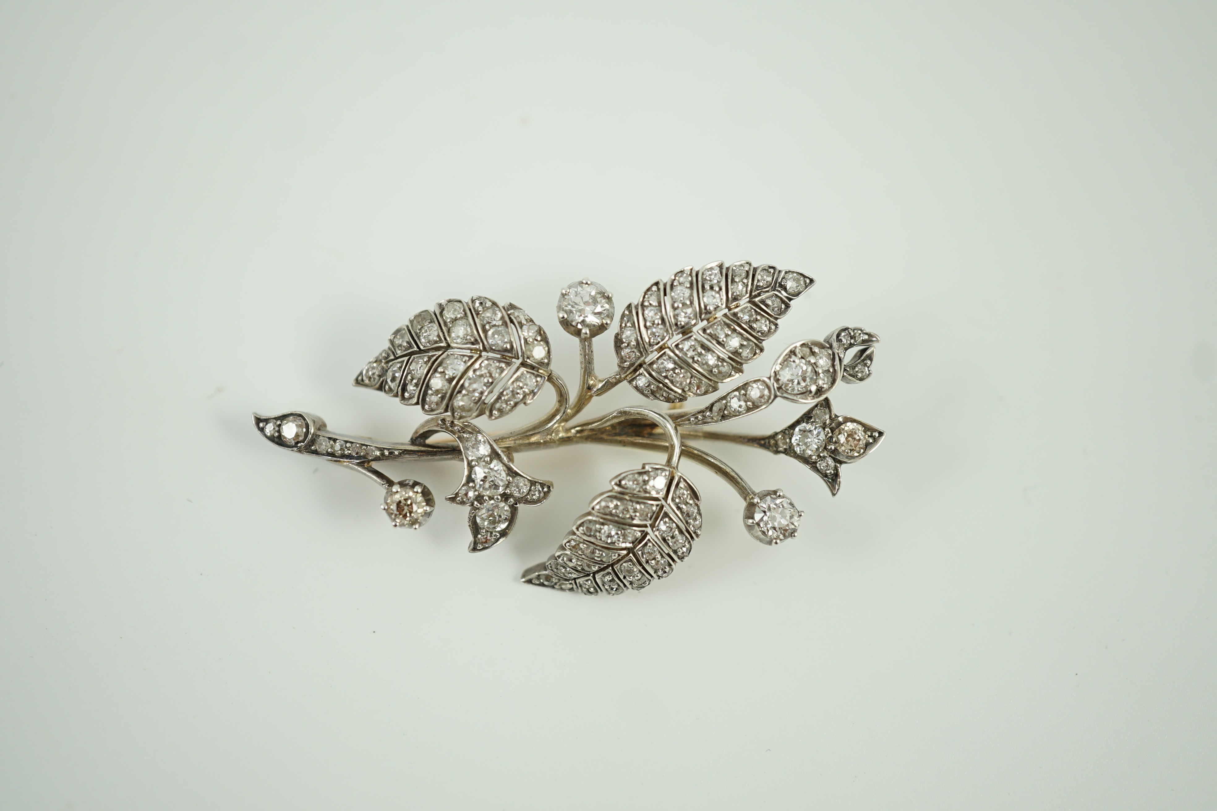 A mid 20th century yellow and white metal, diamond cluster set floral spray brooch, 61mm, gross weight 15.5 grams.
